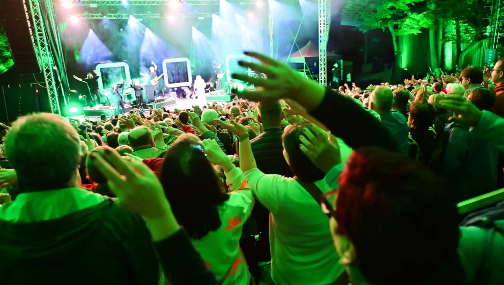 Das Publikum streckt bei einem Konzert auf der Luisenburg die Hände nach oben