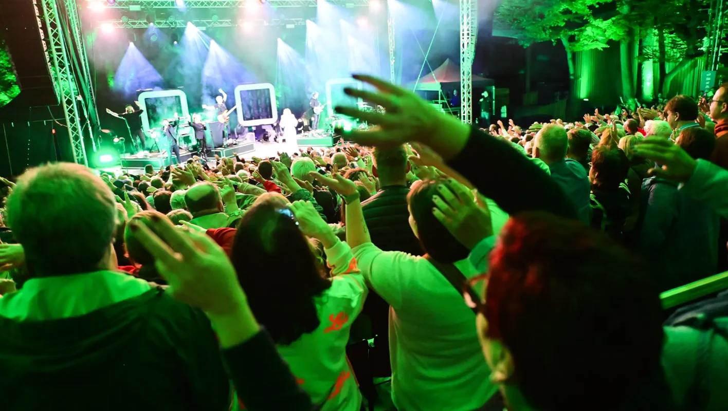 Das Publikum streckt bei einem Konzert auf der Luisenburg die Hände nach oben